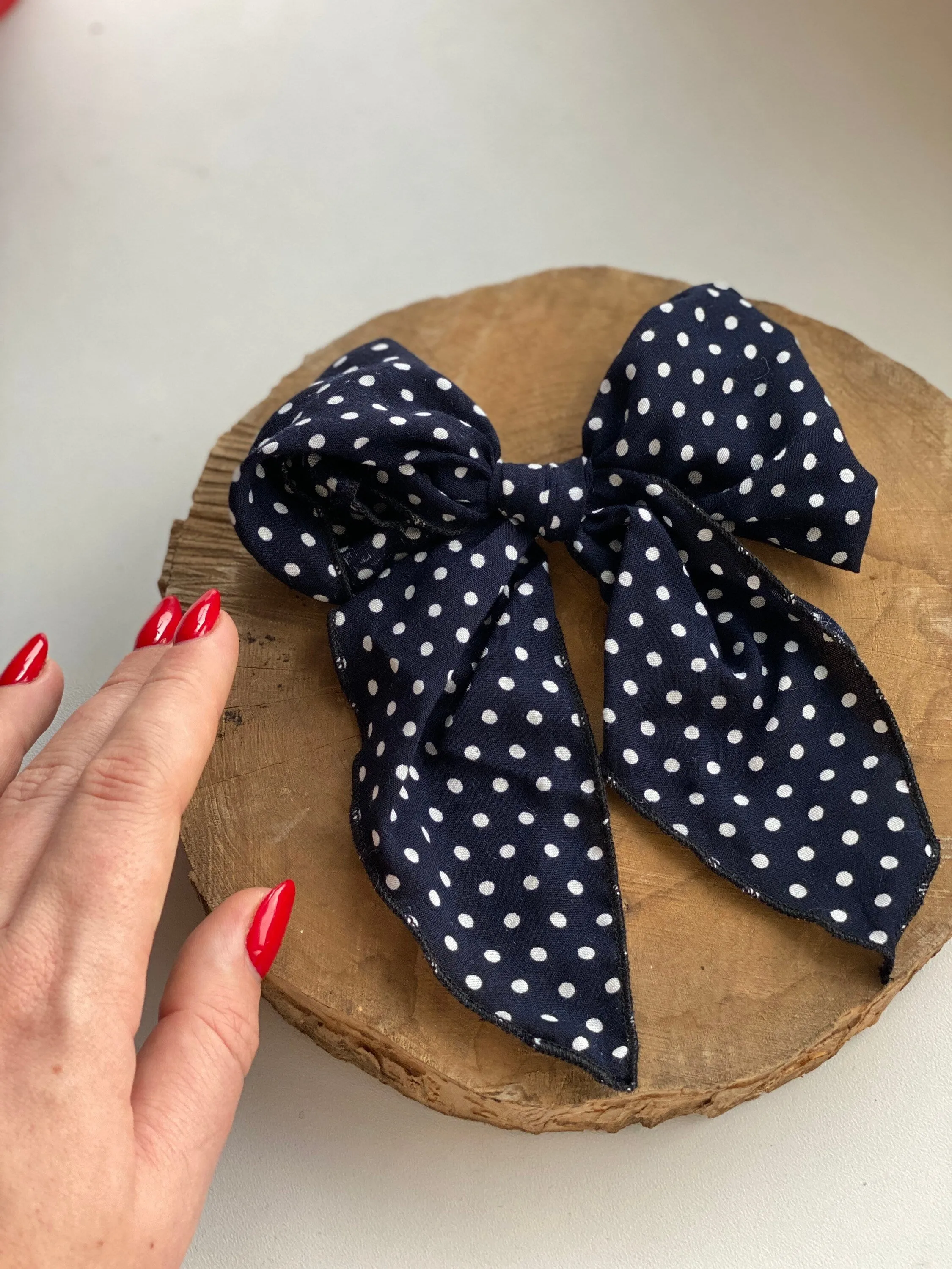 Navy blue polka dot hair bow